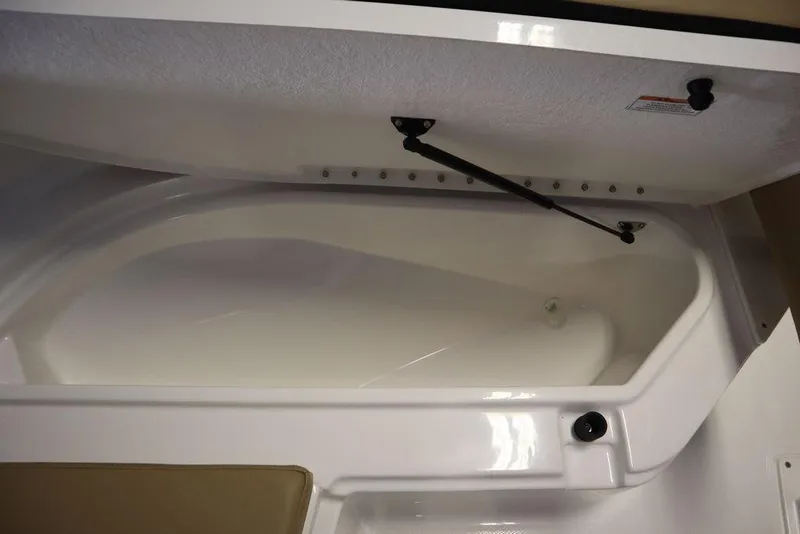 Slide: The Image of 2025 Bayliner 22 CC Trophy storage compartment with open lid, showcasing interior space. - 7