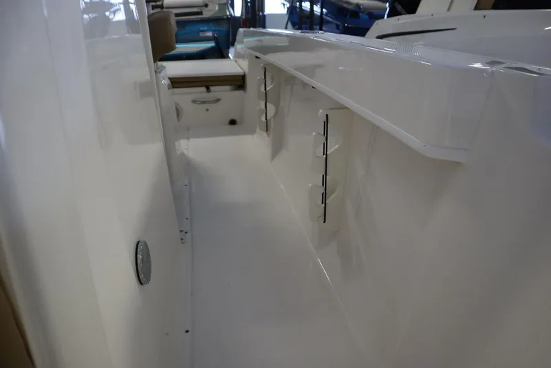 Slide: The Image of 2025 Bayliner 22 CC Trophy boat interior, showcasing sleek white design and spacious layout. - 9