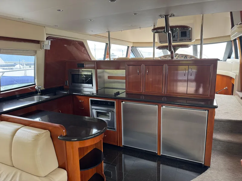 Slide: The Image of Luxurious interior of 2005 Carver 560 Voyager yacht with modern kitchen amenities. - 11