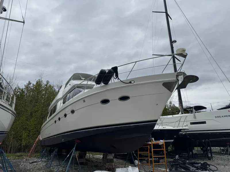 Slide: The Image of 2005 Carver 560 Voyager yacht on dry dock, overcast sky background. - 2