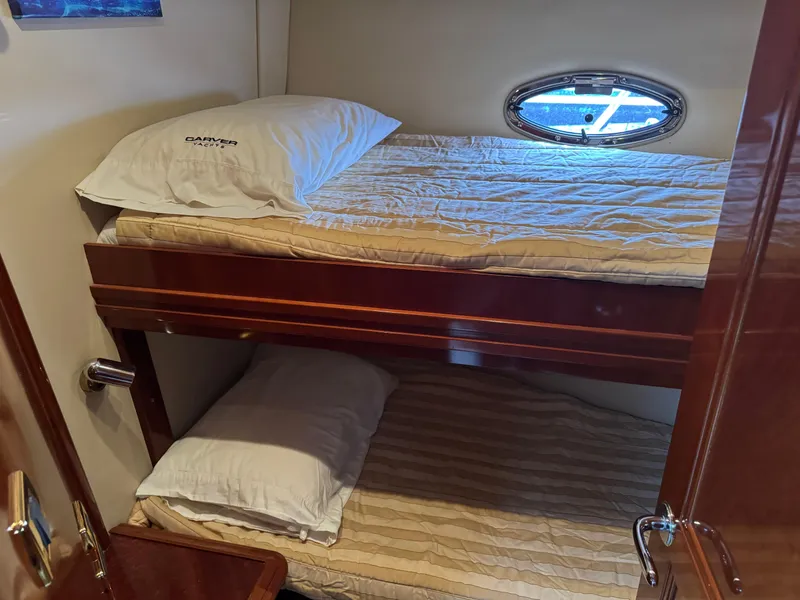 Slide: The Image of Bunk beds in 2005 Carver 560 Voyager yacht cabin with porthole window. - 28