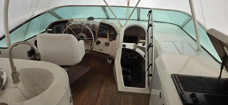 Slide: The Image of Interior view of 2005 Carver 560 Voyager yacht cockpit with steering wheel and controls. - 37