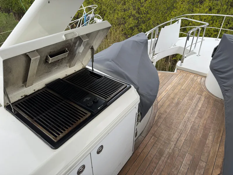 Slide: The Image of 2005 Carver 560 Voyager yacht deck with built-in grill and wooden flooring. - 38