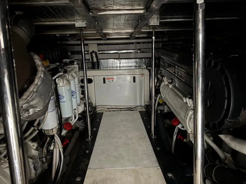 Slide: The Image of Engine room of a 2005 Carver 560 Voyager yacht, showcasing mechanical components and systems. - 40