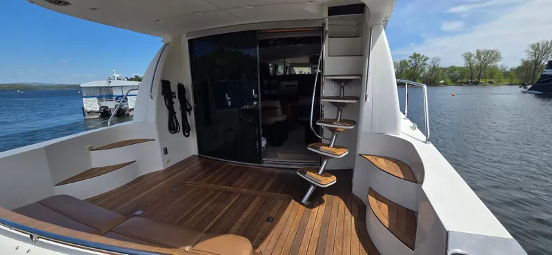 Slide: The Image of 2005 Carver 560 Voyager yacht deck with wooden flooring and spiral staircase. - 5