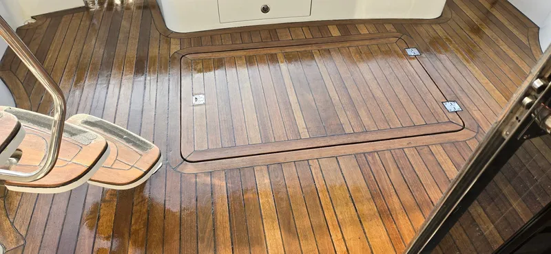 Slide: The Image of Teak deck of 2005 Carver 560 Voyager yacht, featuring polished wood finish. - 6