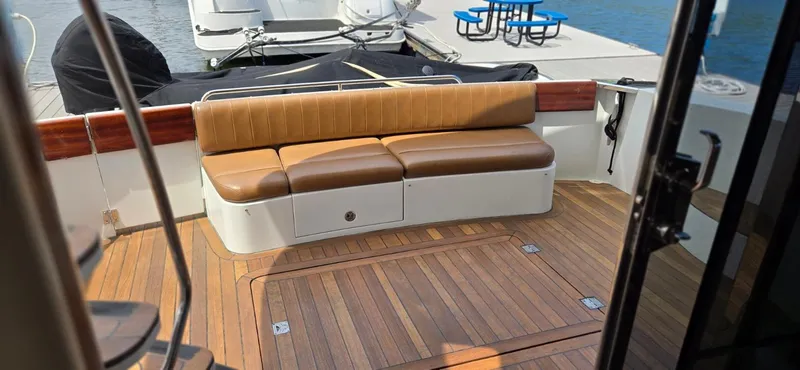 Slide: The Image of 2005 Carver 560 Voyager yacht with teak deck and brown leather seating. - 7