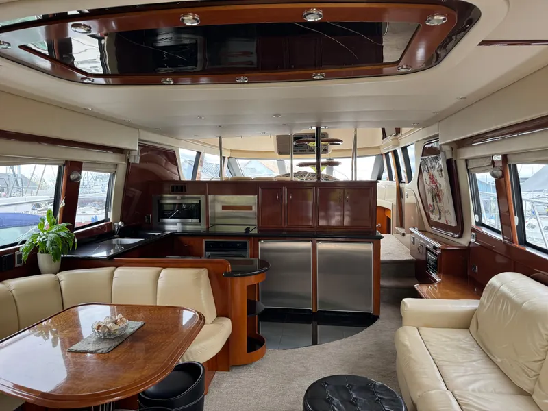 Slide: The Image of Luxurious interior of 2005 Carver 560 Voyager yacht with modern kitchen and seating area. - 8