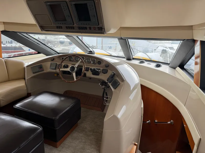 Slide: The Image of 2005 Carver 560 Voyager helm with leather seating and modern navigation controls. - 13
