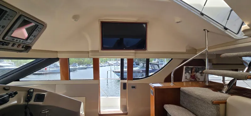Slide: The Image of Interior of 2005 Carver 560 Voyager yacht with helm, stairs, and TV. - 19
