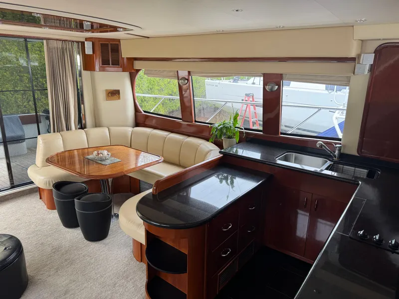 Slide: The Image of Luxurious interior of a 2005 Carver 560 Voyager yacht with elegant dining and kitchen area. - 20