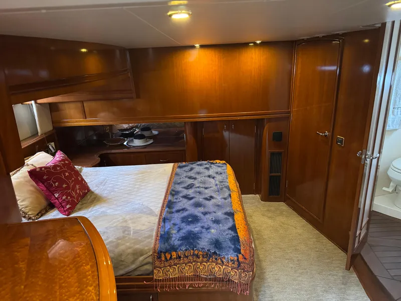Slide: The Image of Luxurious 2005 Carver 560 Voyager cabin with elegant wood finish and cozy bedding. - 22