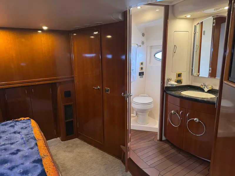 Slide: The Image of Luxurious 2005 Carver 560 Voyager yacht interior with wood finish and modern bathroom. - 23