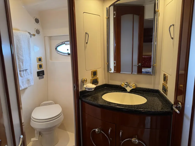 Slide: The Image of Luxurious bathroom in 2005 Carver 560 Voyager yacht with elegant fixtures and porthole window. - 24