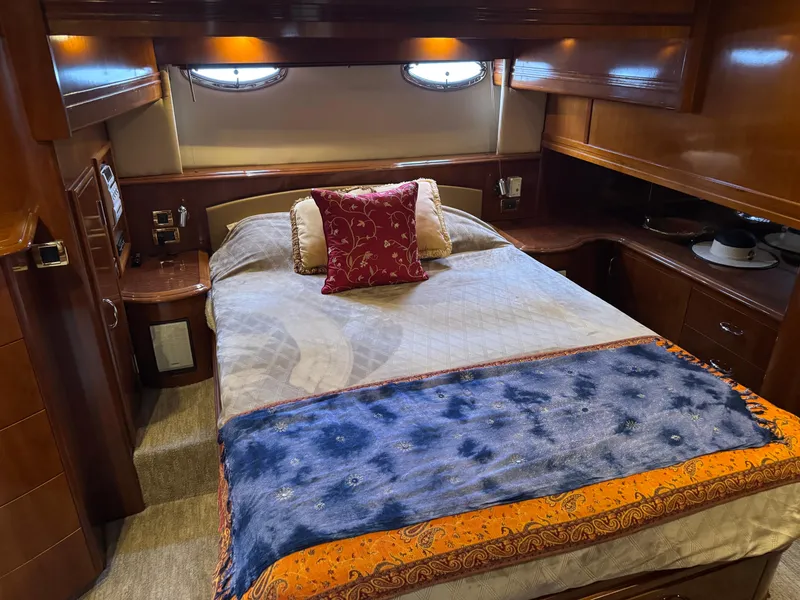 Slide: The Image of Luxurious bedroom interior of 2005 Carver 560 Voyager yacht with elegant bedding and wood finish. - 25