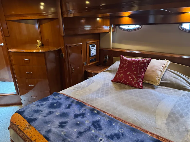 Slide: The Image of Luxurious cabin interior of 2005 Carver 560 Voyager yacht with elegant bedding and wood finish. - 26