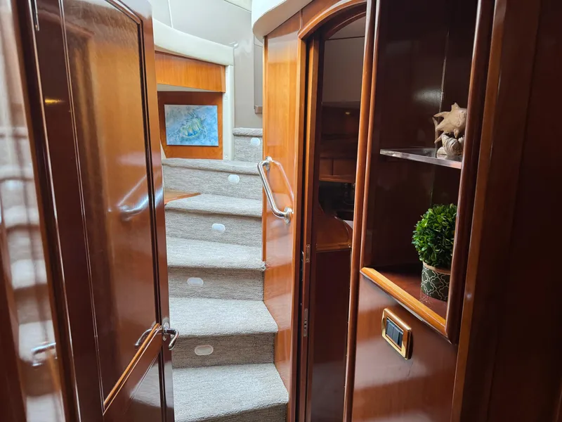 Slide: The Image of Interior of 2005 Carver 560 Voyager yacht with wooden finishes and carpeted stairs. - 31