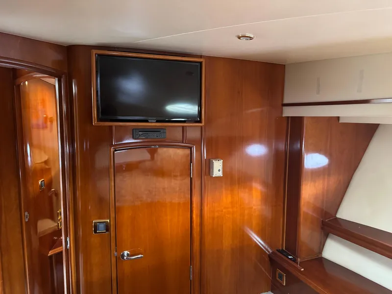 Slide: The Image of Interior of 2005 Carver 560 Voyager yacht with wood paneling and mounted TV. - 32