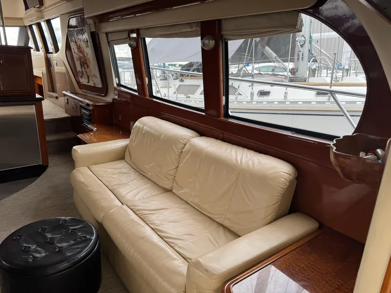 Slide: The Image of Luxurious interior of 2005 Carver 560 Voyager yacht with cream leather sofa and large windows. - 9