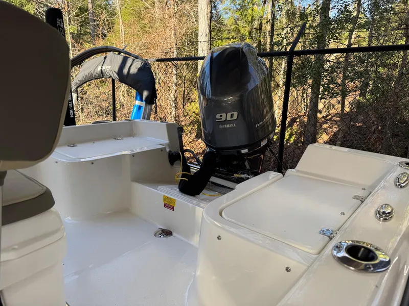 Slide: The Image of 2025 Key West 1720 Center Console boat with 90 HP engine, outdoor setting. - 10