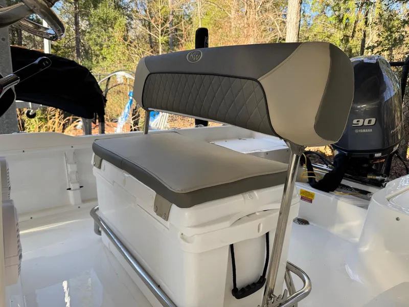 Slide: The Image of 2025 Key West 1720 Center Console boat interior with cushioned seating and outboard motor. - 11