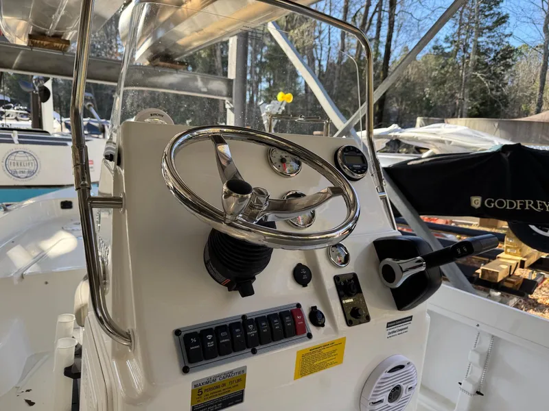 Slide: The Image of 2025 Key West 1720 Center Console boat dashboard with steering wheel and controls. - 14