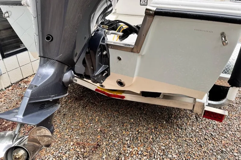 Slide: The Image of 2025 Key West 1720 Center Console boat with outboard motor on gravel. - 16