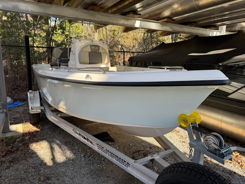 Slide: The Image of 2025 Key West 1720 Center Console boat on trailer, parked under shelter. - 4