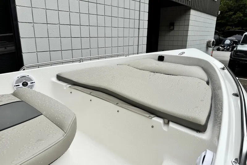 Slide: The Image of 2025 Key West 1720 Center Console boat with cushioned seating, wet from rain. - 7
