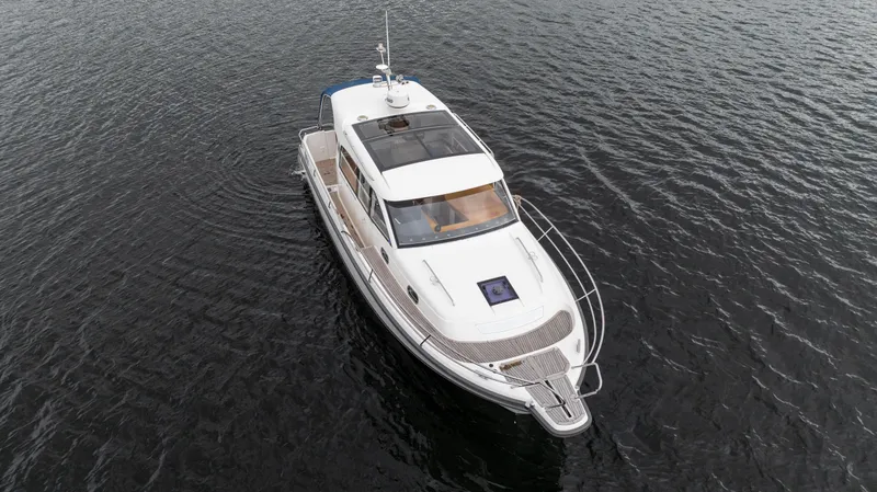 Slide: The Image of 2017 Nimbus 365 Coupe yacht cruising on calm waters, aerial view. - 11