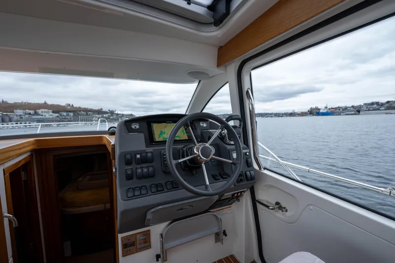 Slide: The Image of Interior view of 2017 Nimbus 365 Coupe boat cockpit with steering wheel and navigation system. - 22