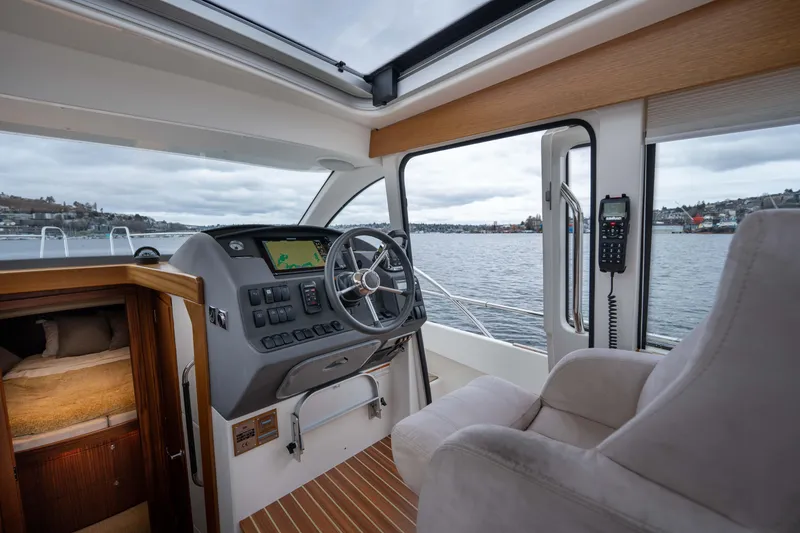 Slide: The Image of Interior view of 2017 Nimbus 365 Coupe boat cockpit with steering wheel and navigation system. - 24