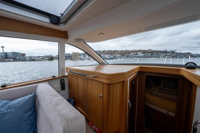 Slide: The Image of Interior view of 2017 Nimbus 365 Coupe yacht with wooden cabinetry and waterfront scenery. - 25