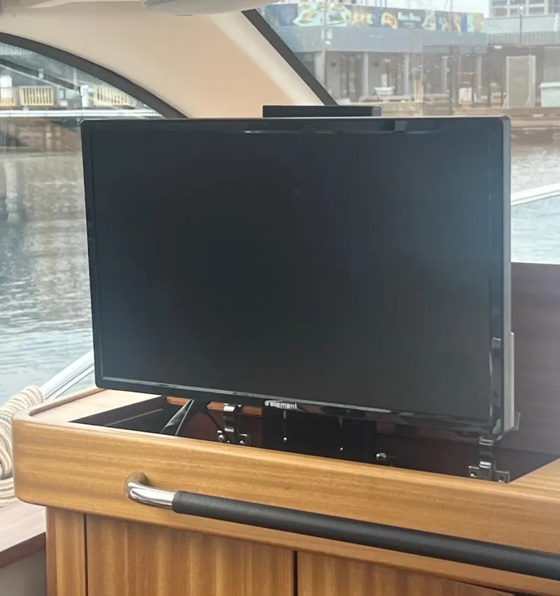 Slide: The Image of Flat-screen TV on 2017 Nimbus 365 Coupe yacht, docked by the water. - 26