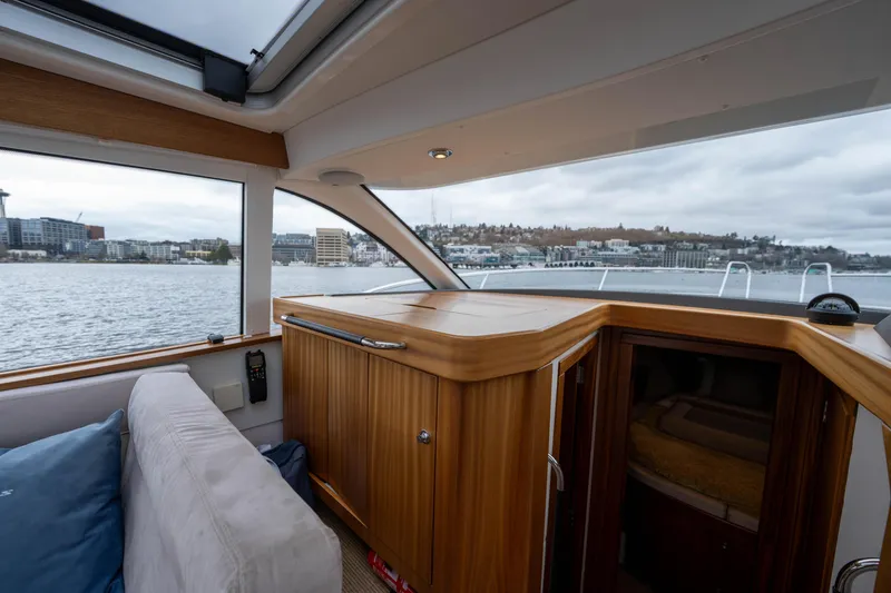 Slide: The Image of Interior of 2017 Nimbus 365 Coupe yacht with wooden cabinetry and waterfront view. - 27