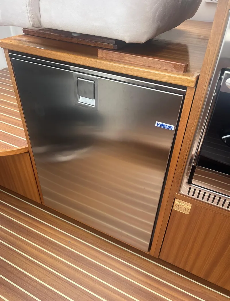 Slide: The Image of Stainless steel fridge in 2017 Nimbus 365 Coupe boat interior. - 29