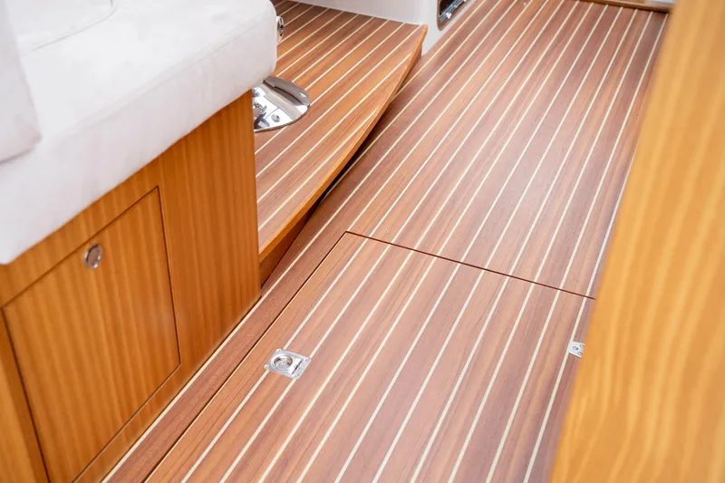 Slide: The Image of Interior view of 2017 Nimbus 365 Coupe with wooden flooring and storage compartment. - 34