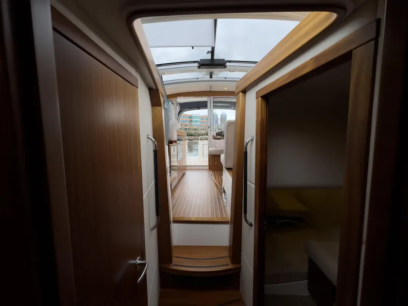 Slide: The Image of Interior view of 2017 Nimbus 365 Coupe yacht, featuring wooden finishes and modern design. - 36