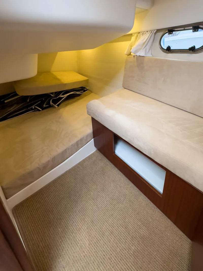 Slide: The Image of Cozy interior cabin of 2017 Nimbus 365 Coupe with beige seating and window. - 38