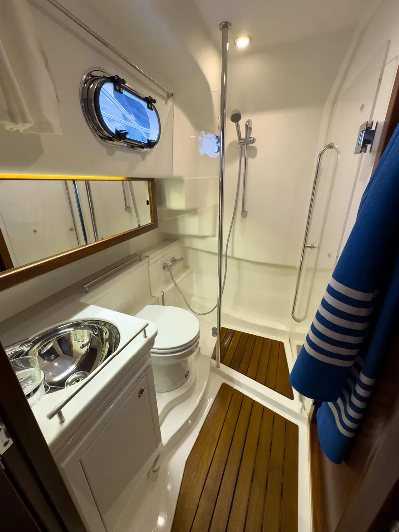 Slide: The Image of 2017 Nimbus 365 Coupe bathroom with shower, wooden flooring, and nautical decor. - 39