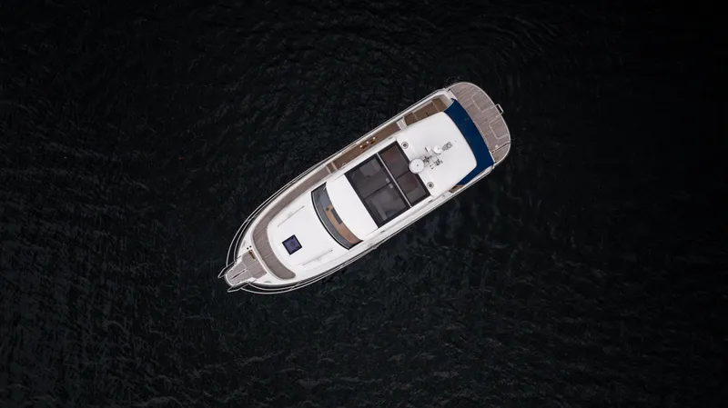 Slide: The Image of Aerial view of 2017 Nimbus 365 Coupe boat on dark water. - 7