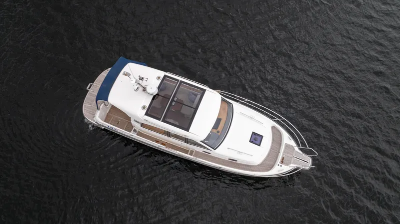 Slide: The Image of Aerial view of 2017 Nimbus 365 Coupe boat on dark water. - 8