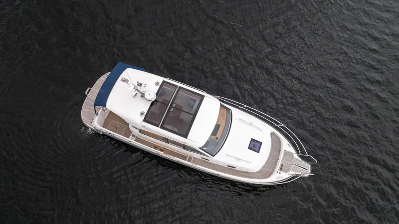 Slide: The Image of Aerial view of 2017 Nimbus 365 Coupe boat on dark water. - 9