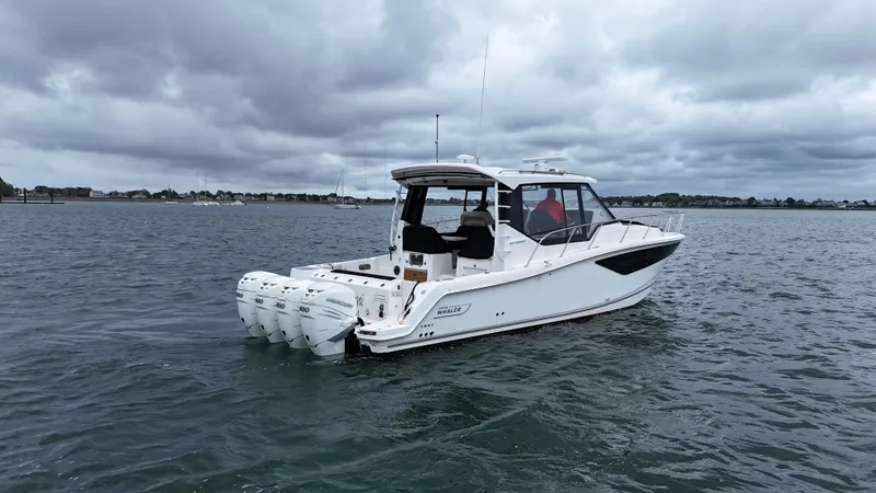 Slide: The Image of 2021 Boston Whaler 405 Conquest boat on water under cloudy sky. - 0