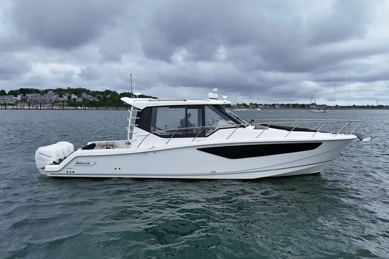 Slide: The Image of 2021 Boston Whaler 405 Conquest boat on water under cloudy sky. - 1