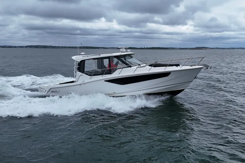 Slide: The Image of Boston Whaler 405 Conquest 2021 cruising on open water under cloudy skies. - 10