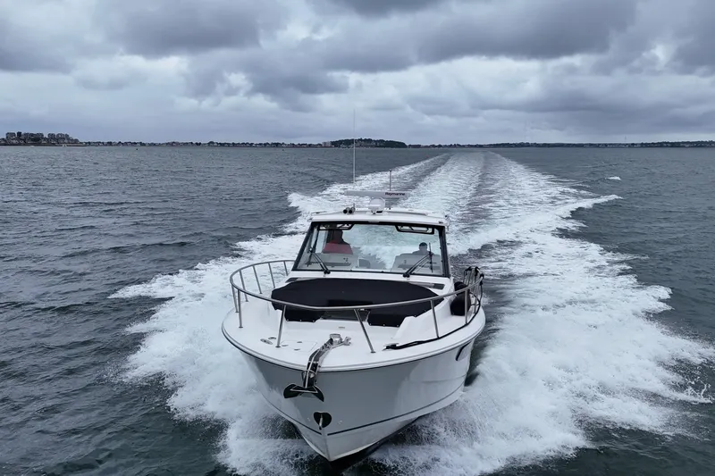 Slide: The Image of 2021 Boston Whaler 405 Conquest cruising on open water under cloudy skies. - 11