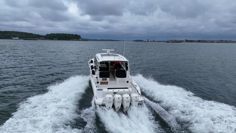 Slide: The Image of Boston Whaler 405 Conquest 2021 cruising on open water under cloudy skies. - 12
