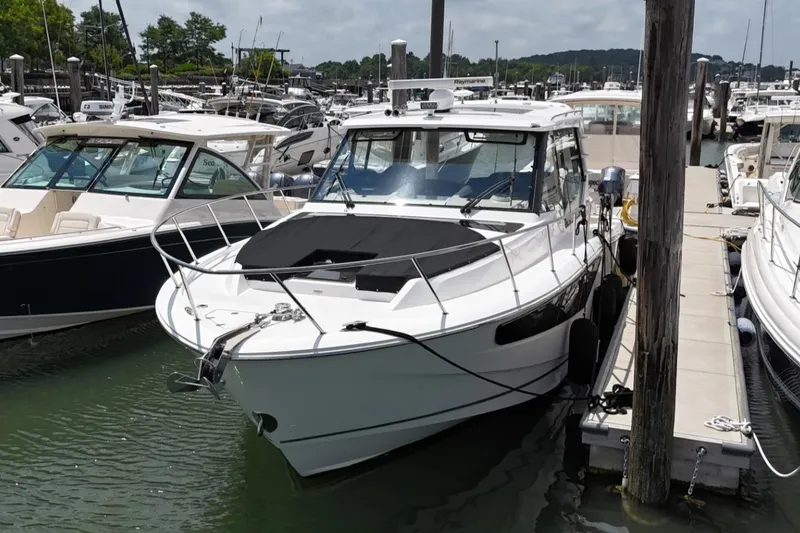 Slide: The Image of 2021 Boston Whaler 405 Conquest docked at a marina, surrounded by other boats. - 15