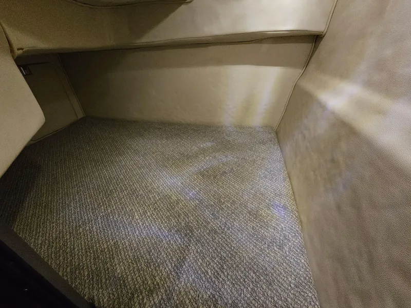 Slide: The Image of 2003 Chaparral 260 Signature Cruiser interior cabin with beige carpet and upholstery. - 10